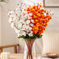 Artificial flower bouquet with realistic silk flowers, vibrant mixed blooms, decorative green leaves, and flexible stems arranged beautifully for home décor, wedding décor, gifting, and table decoration.