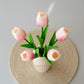 Decorative vase with pink tulips on a textured surface