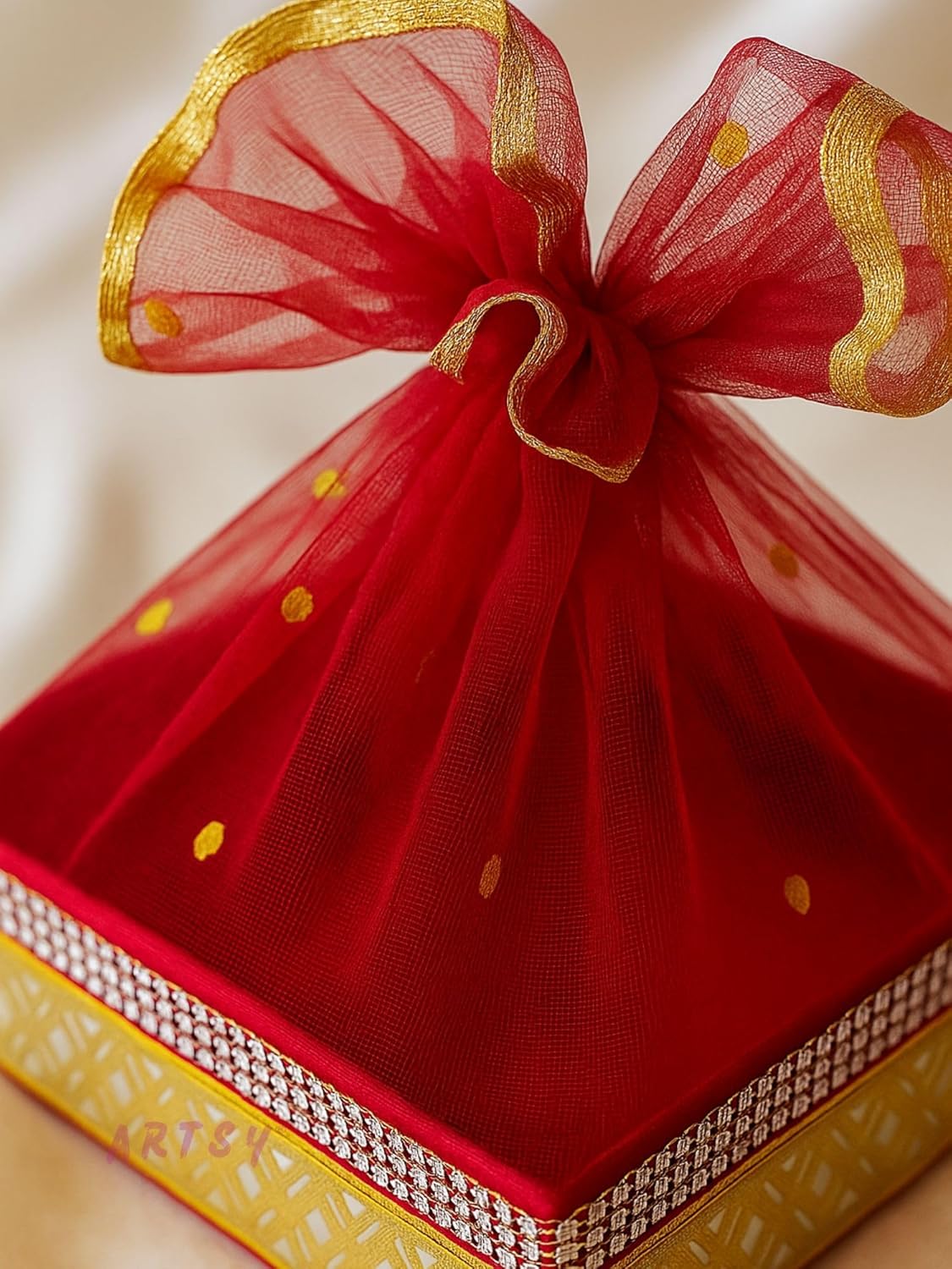 close up of handcrafted red net gift basket with golden detailing