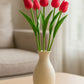 red artificial tulips in vase